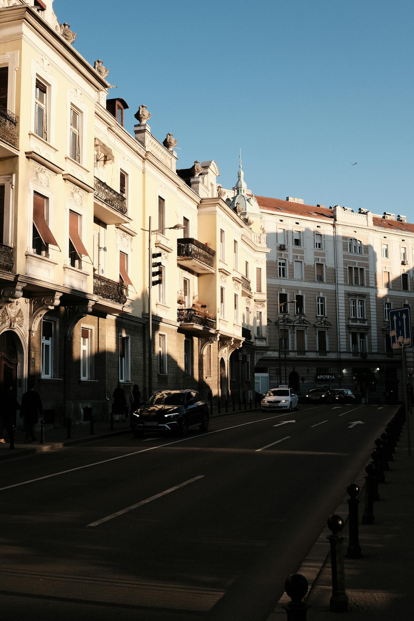 A beautiful street in Belgrade, Serbia, showcasing classic buildings and urban life at dusk.