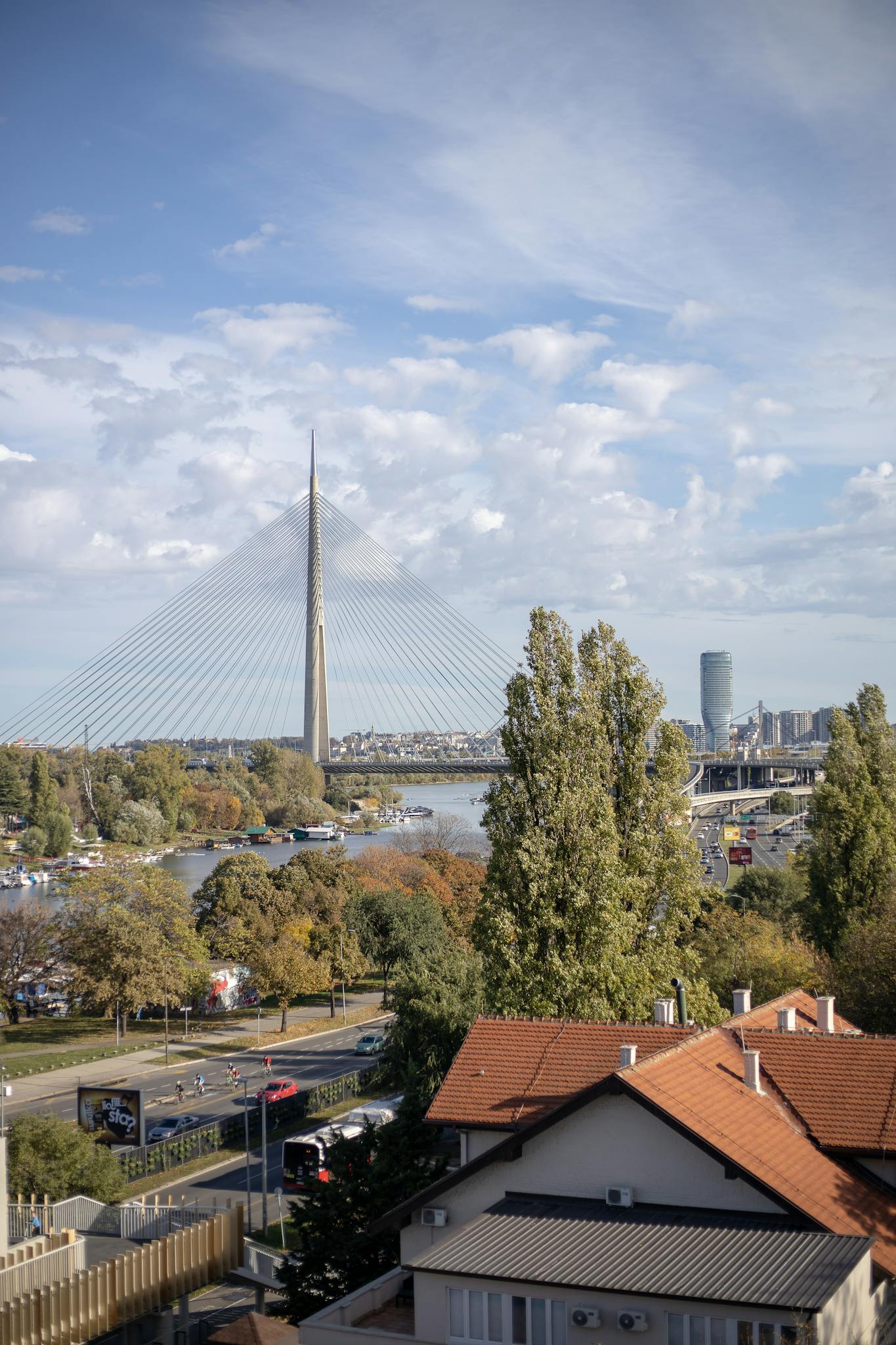 Stunning view of Ada Bridge and Belgrade cityscape on a sunny day with vibrant trees. for Contact me page