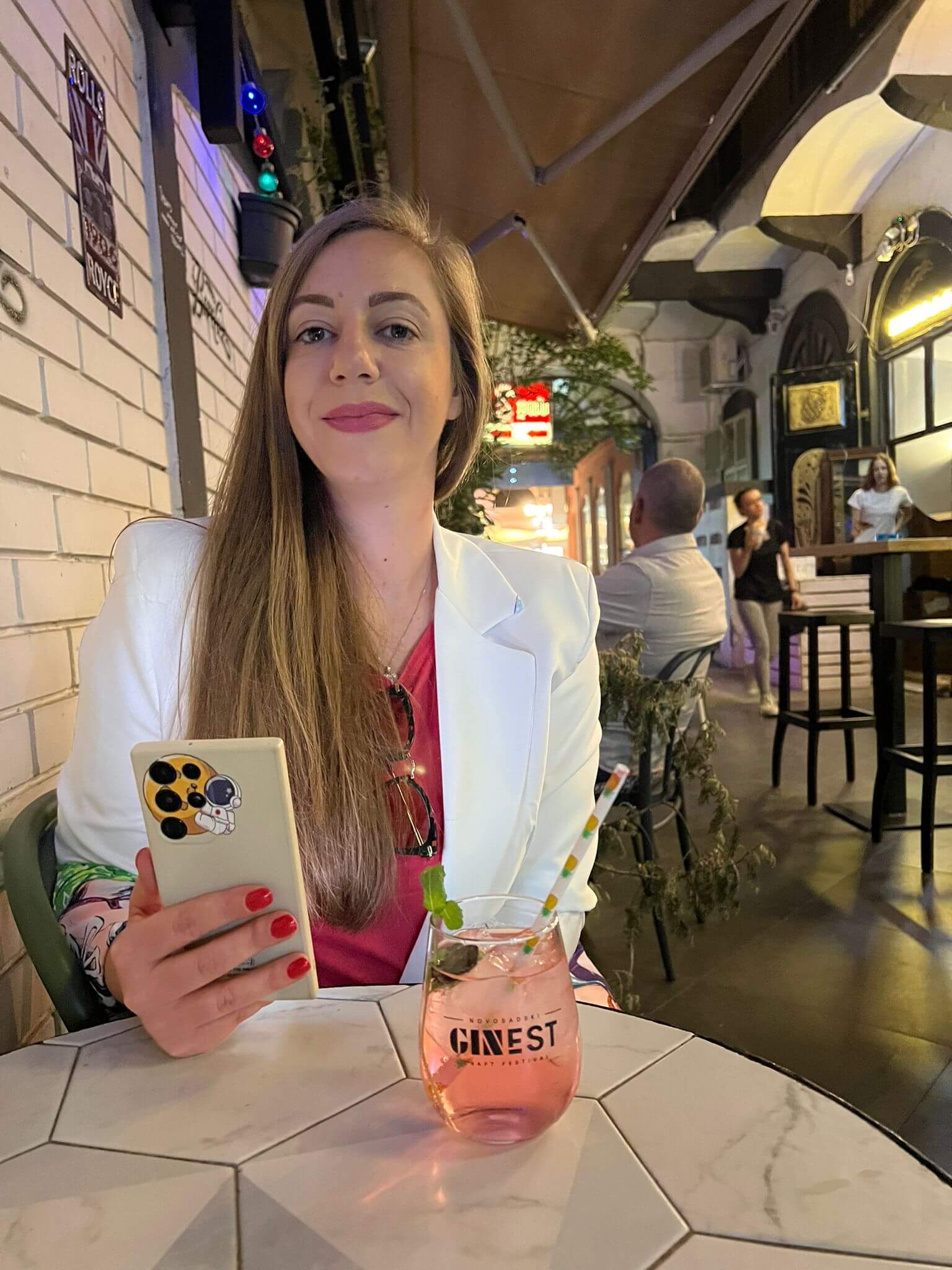 Enjoying a pink gin cocktail at a Gin Fest in Novi Sad, Serbia