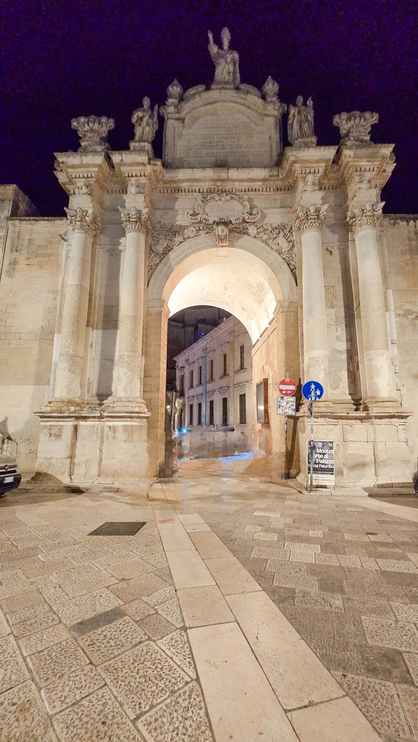 Porta Rudiae city gate in Lecce, Puglia, illuminated at night.