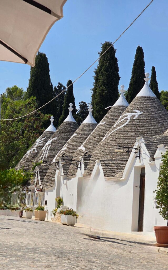 A row of trulli houses in Alberobello with symbolic roofs.