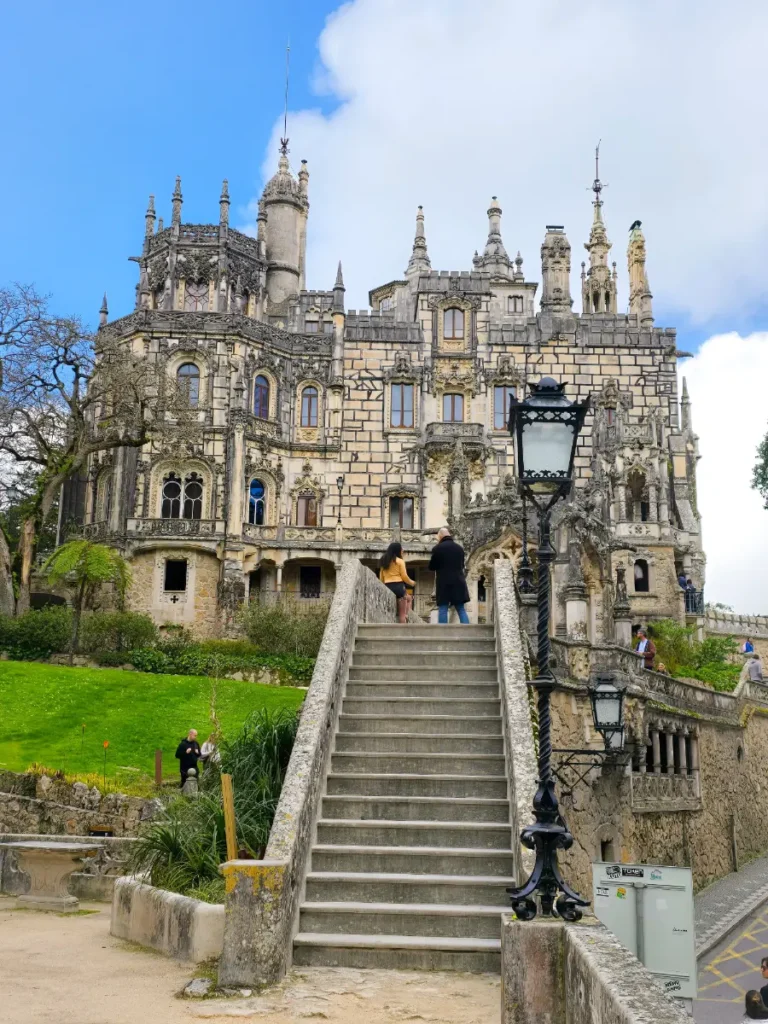 Front view of Quinta da Regaleira in Sintra, Portugal, showing its grand staircase and gothic architecture.