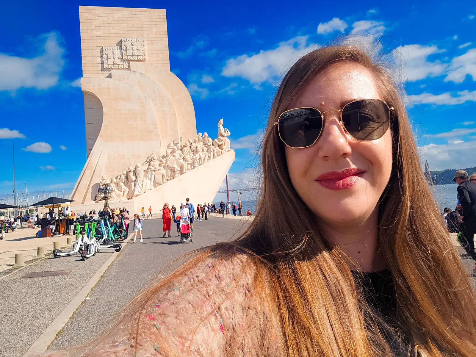 Traveler posing at the Monument to the Discoveries in Belém, Lisbon, Portugal.