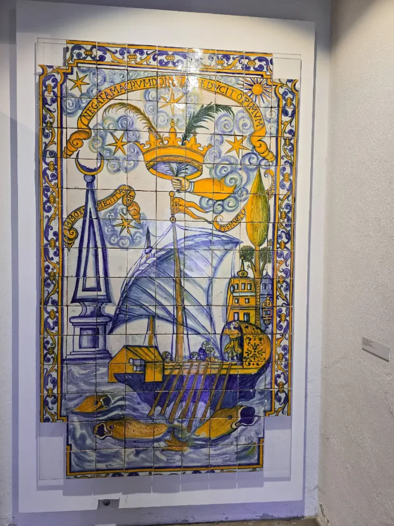 Colorful traditional Portuguese azulejo tile panel depicting a ship and crown at the National Tile Museum in Lisbon.