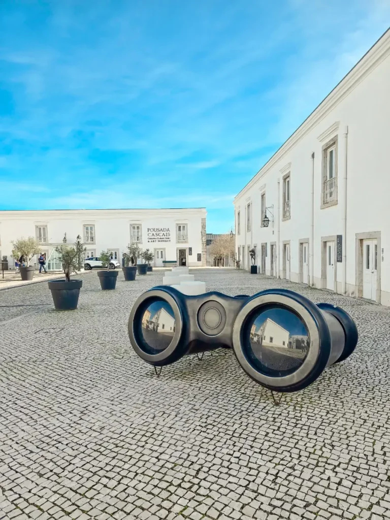 Courtyard of Pousada de Cascais Art District with modern sculpture and white buildings