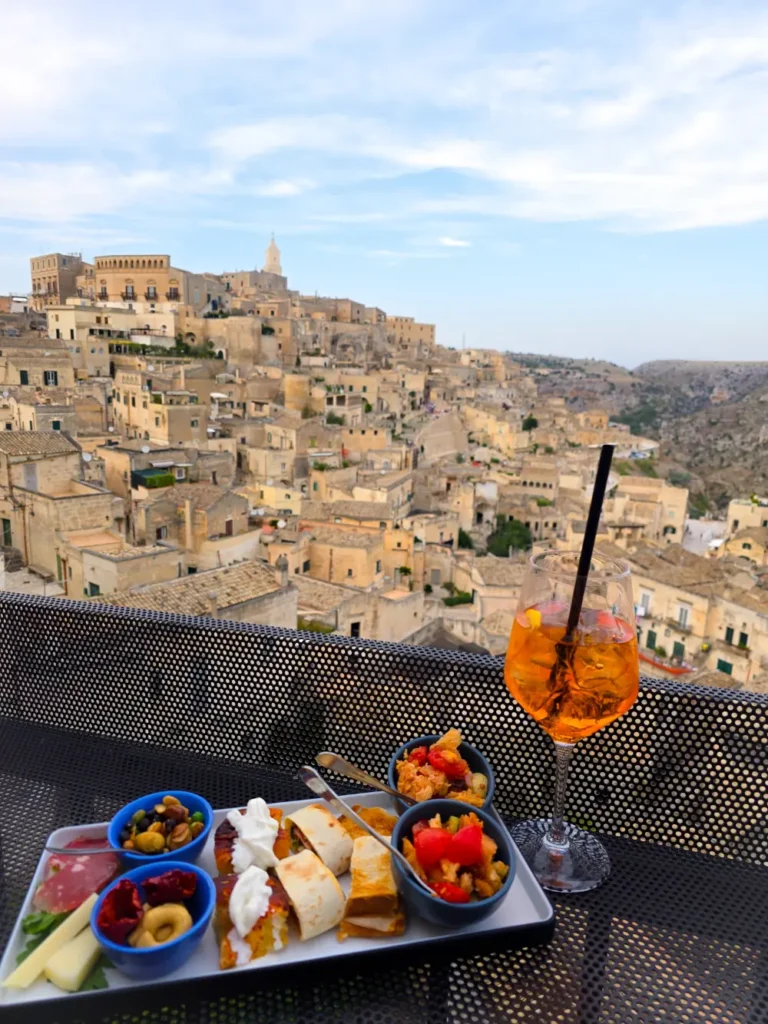 Aperol spritz and Italian antipasti with a view of Matera’s old town. part of matera travel guide and things to do in Matera
