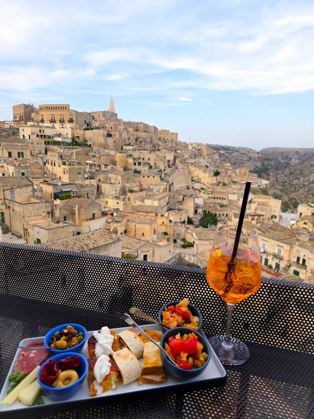 Aperol spritz and Italian antipasti with a view of Matera’s old town. part of matera travel guide and things to do in Matera