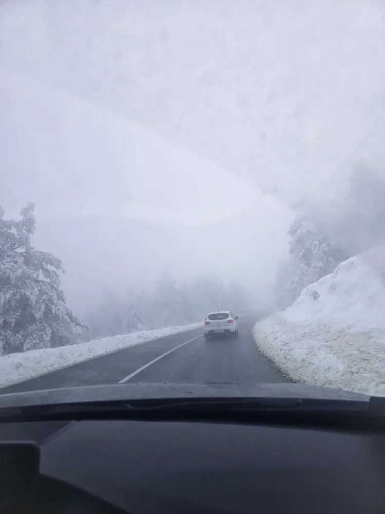 Car driving on a snowy mountain road toward Divčibare, a popular place for skiing near Belgrade