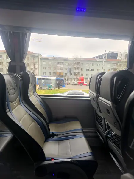 Comfortable leather interior seats of the City Bus coach in Georgia, showing the clean and modern travel environment for the trip to Tbilisi.
