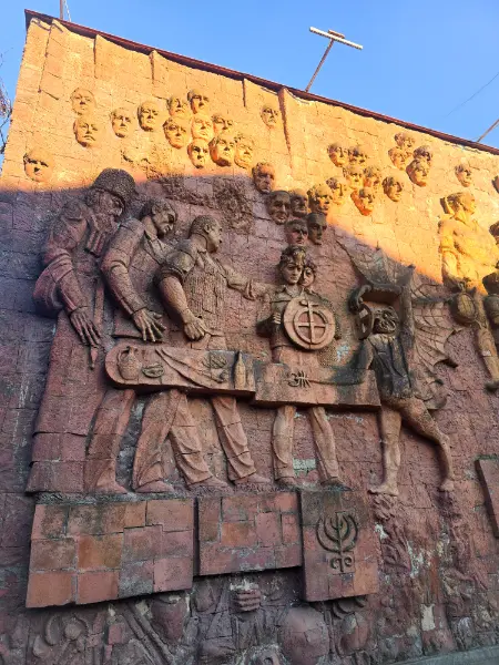 Detailed view of the Soviet-era bas-relief on the Green Bazaar facade, showcasing Georgian cultural history in this Kutaisi travel guide.